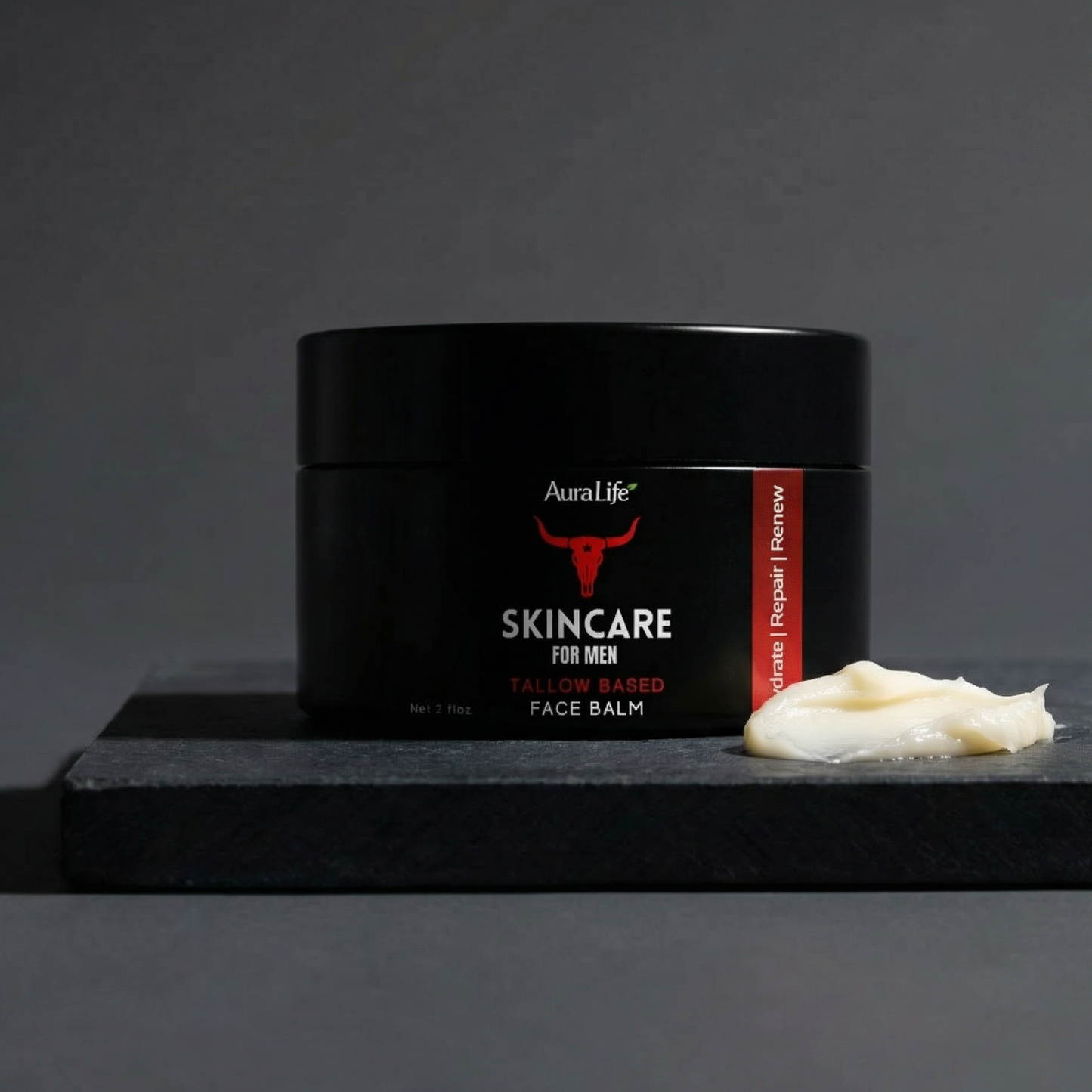 Black jar of AuraLife skincare for men on a dark surface with a gray background