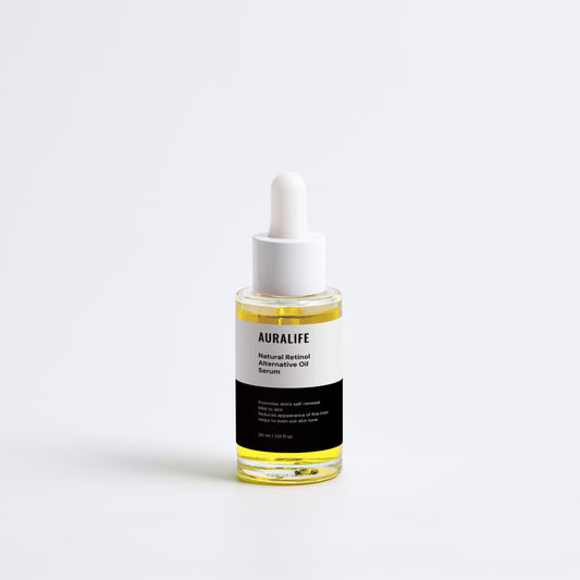 Bottle of Auralife hair oil with dropper on a white background